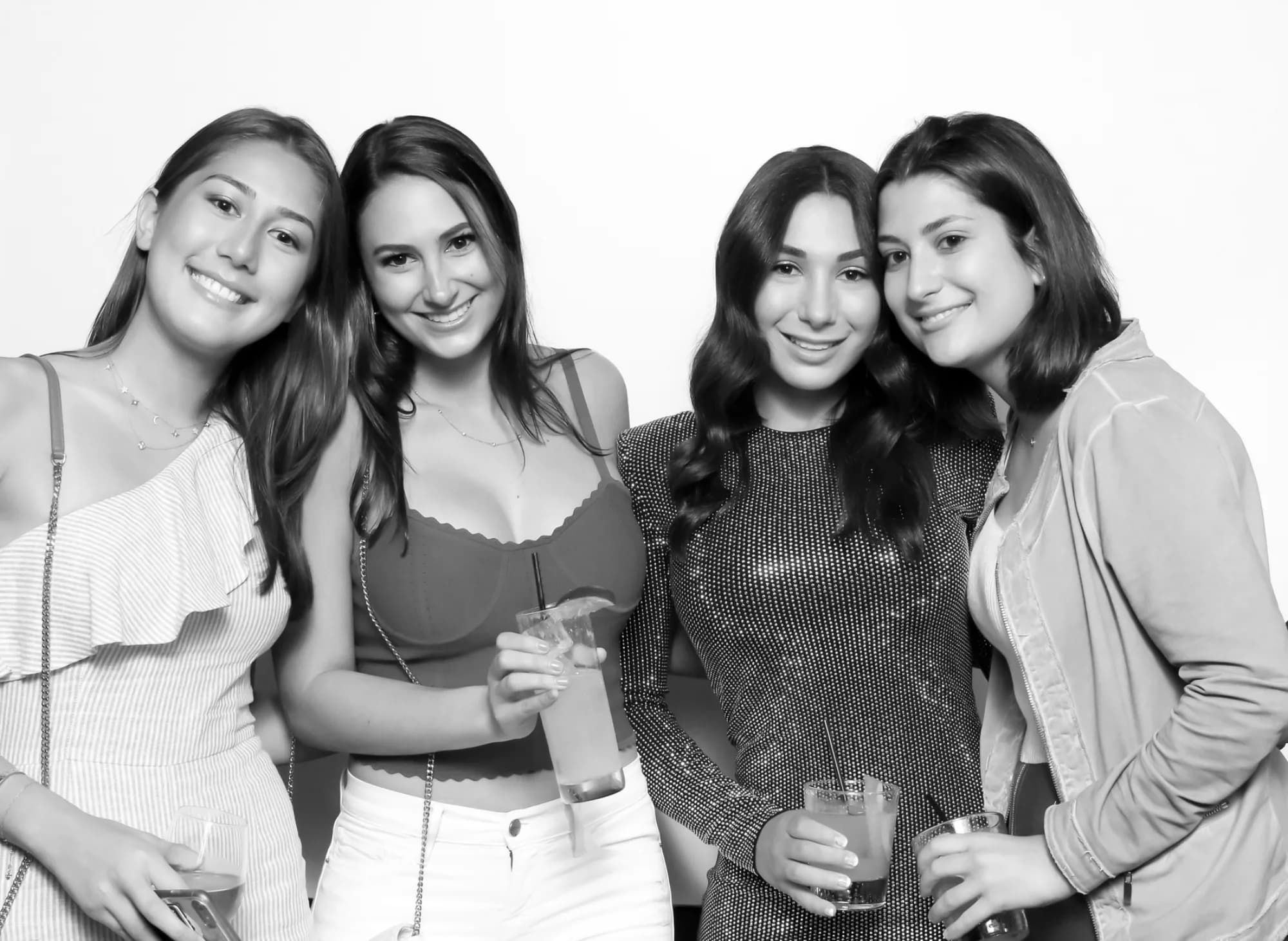 Glam photo booth black-and-white group portrait of four guests at a New York event