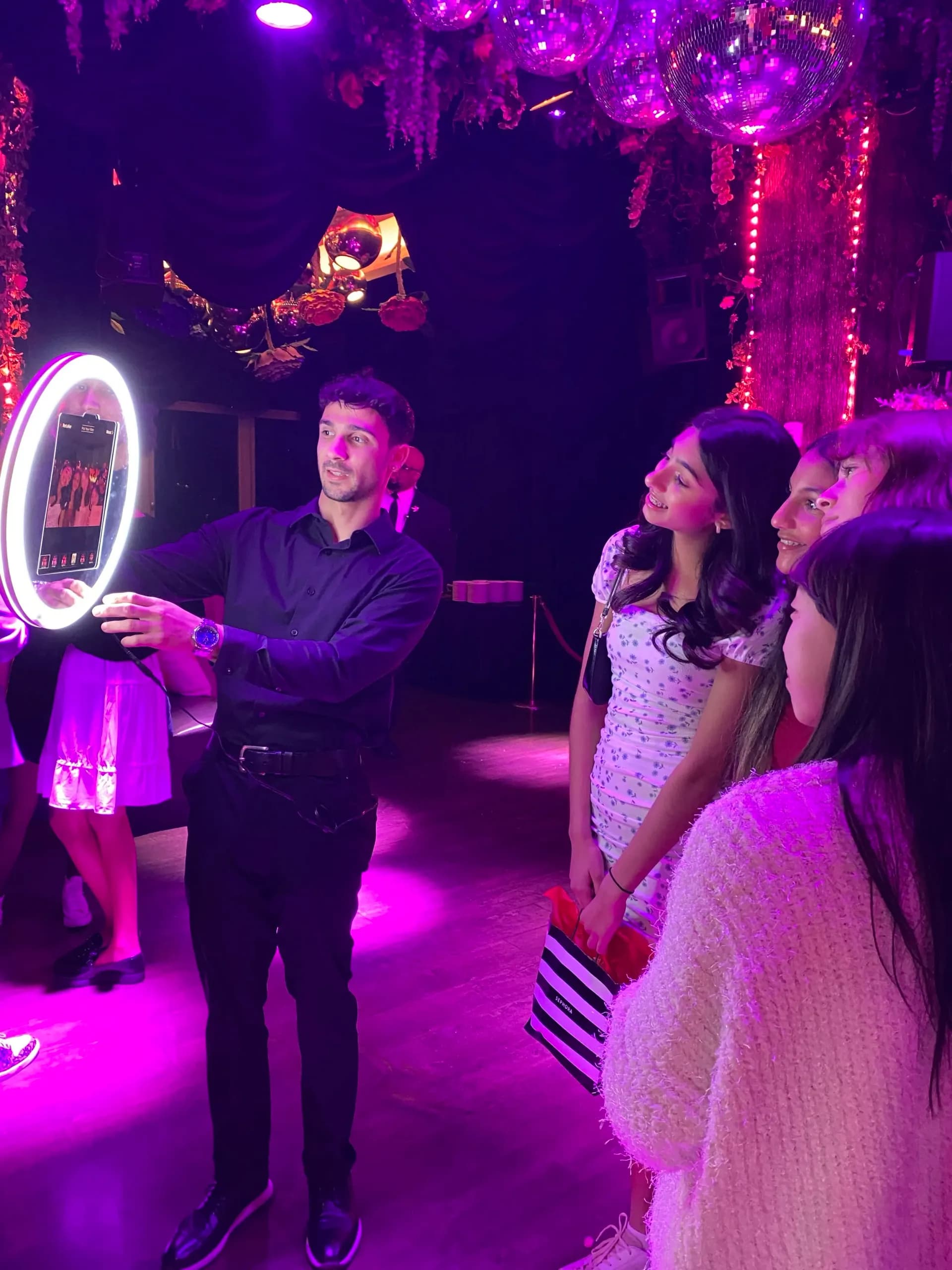 Roamer photo booth attendant showing guests their photo preview at a NYC event