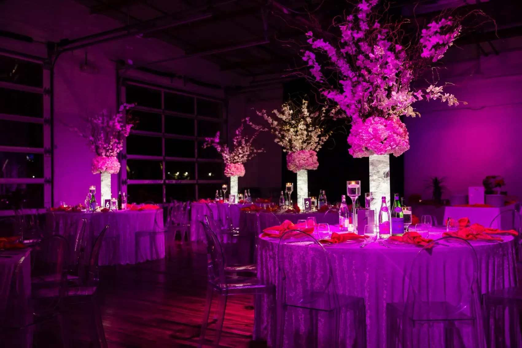 Bat mitzvah reception with pink uplighting and florals in the boathouse at The Knowlton waterfront venue in Fairfield County CT