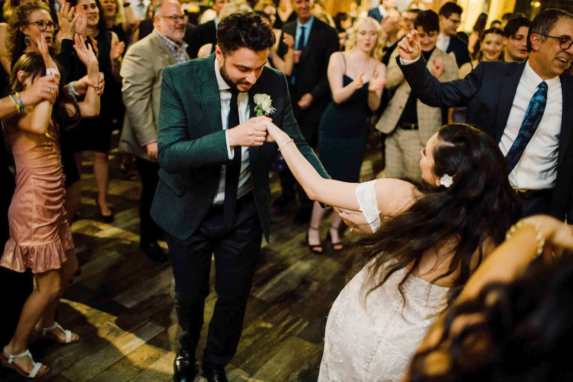 Wedding guests filling a formal dance floor while an experienced DJ runs the night for Nicholson Events
